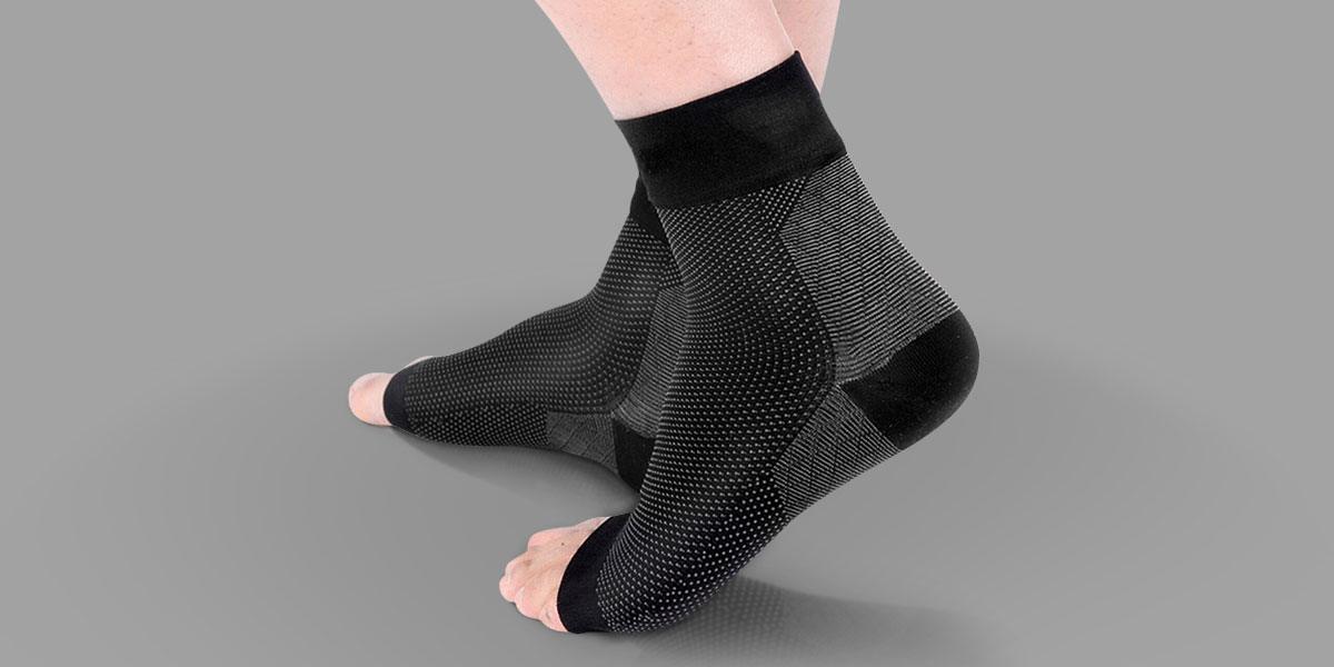 Feet wearing ankle compression sleeves